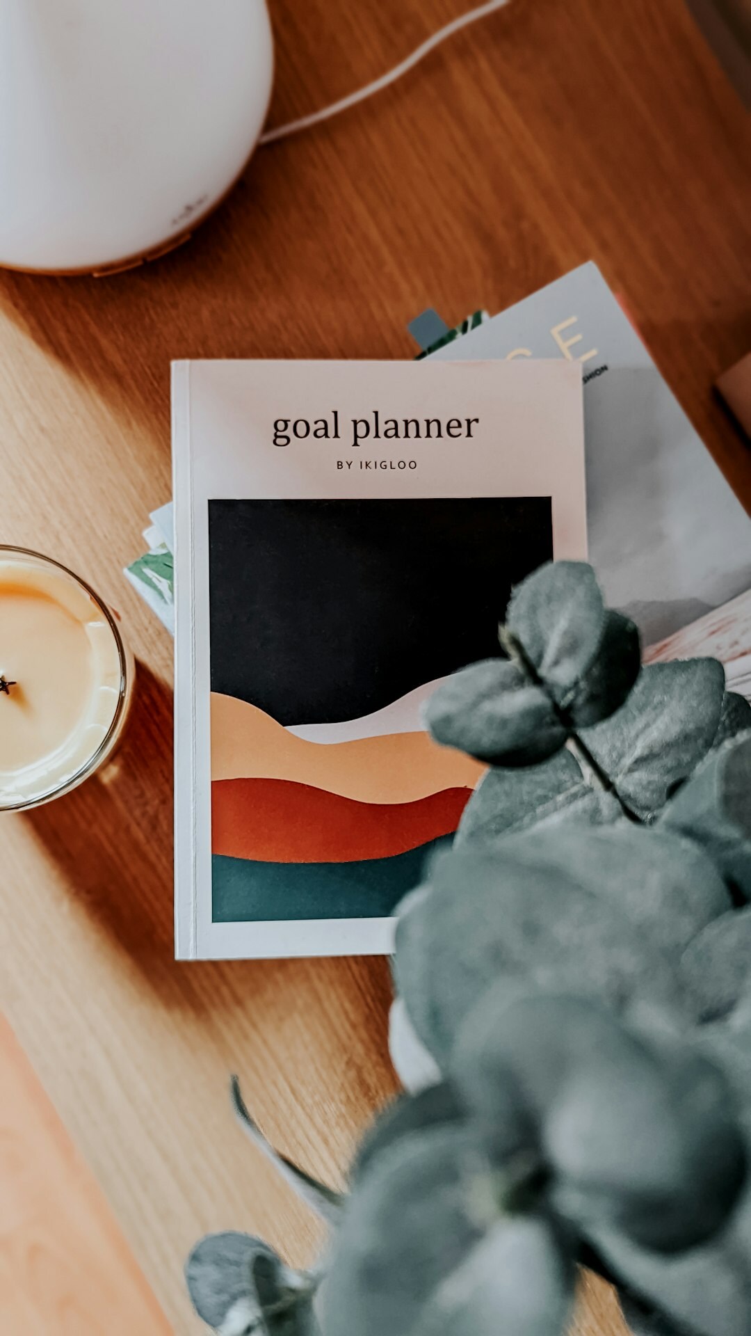 Flat lay of glossy lifestyle magazines on a wooden table